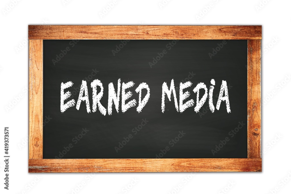 EARNED MEDIA text written on wooden frame school blackboard. EARNED MEDIA text written on wooden frame school blackboard.