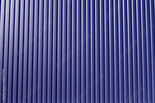 Ridged blue metal wall background.
