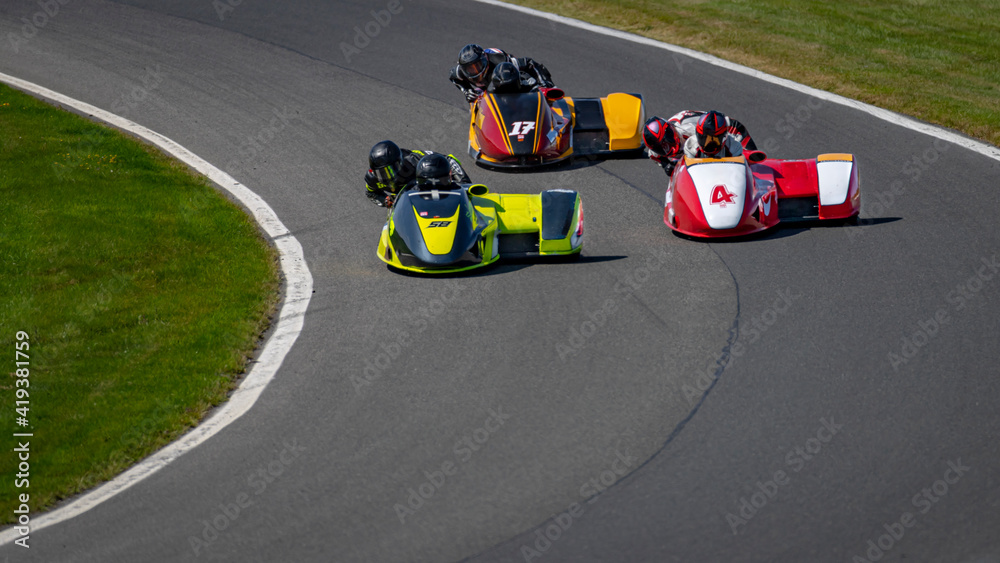 Obraz premium A shot of a racing sidecar as it corners on a track.
