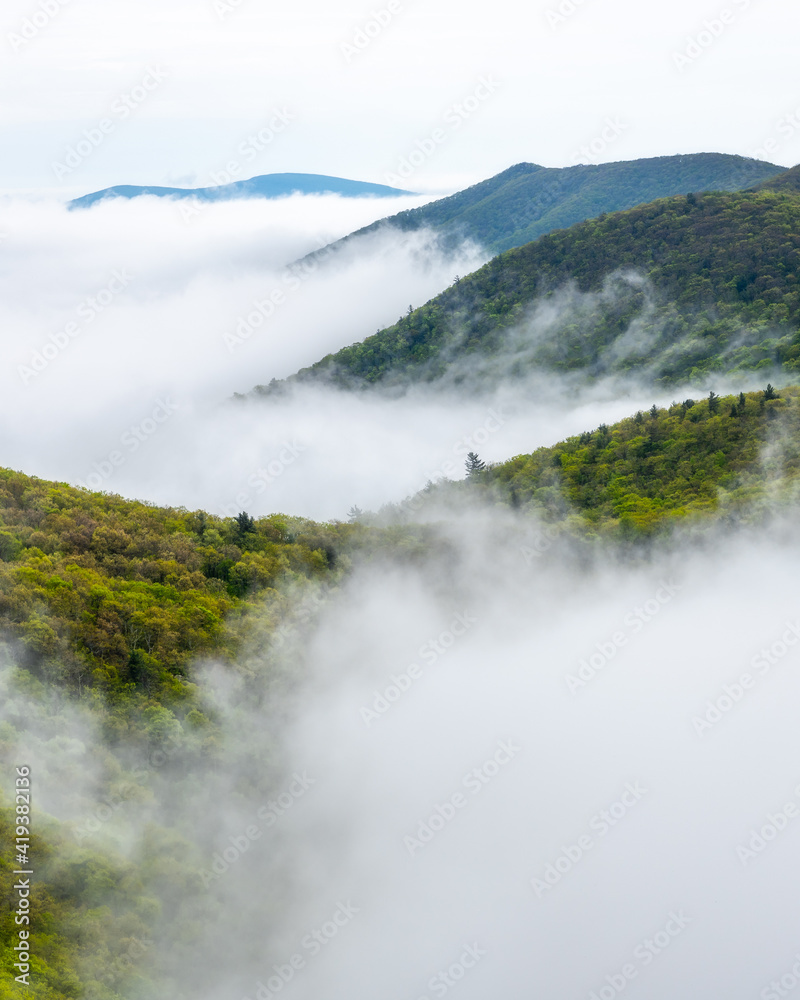 Layers and ridges of Shenandoah National Park poking through the sea of fog filling the valleys below. Layers and ridges of Shenandoah National Park poking through the sea of fog filling the valleys below.