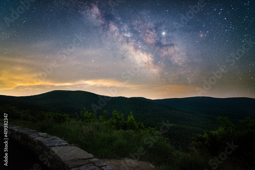 Fototapeta Naklejka Na Ścianę i Meble -  The Milky Way glowing over the valleys of Shenandoah National Park during the Summer.