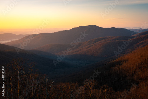 Dawn in Shenandoah National Park as the golden light illuminates the valleys around Old Rag Mountain. © Nick