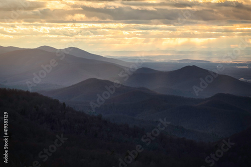 Golden crepuscular rays on a frigidly windy evening in Shenandoah National Park. © Nick