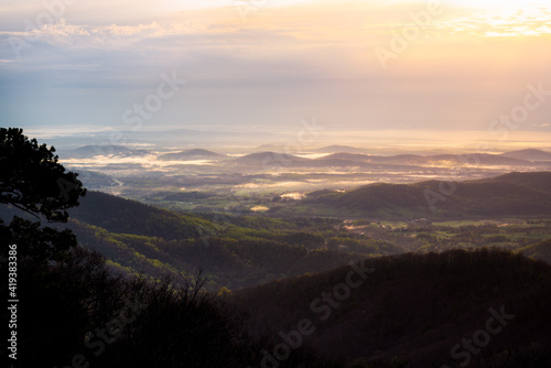 A wide view of the morning glow down into the farmlands of the Virginian piedmont around Shenandoah National Park. © Nick