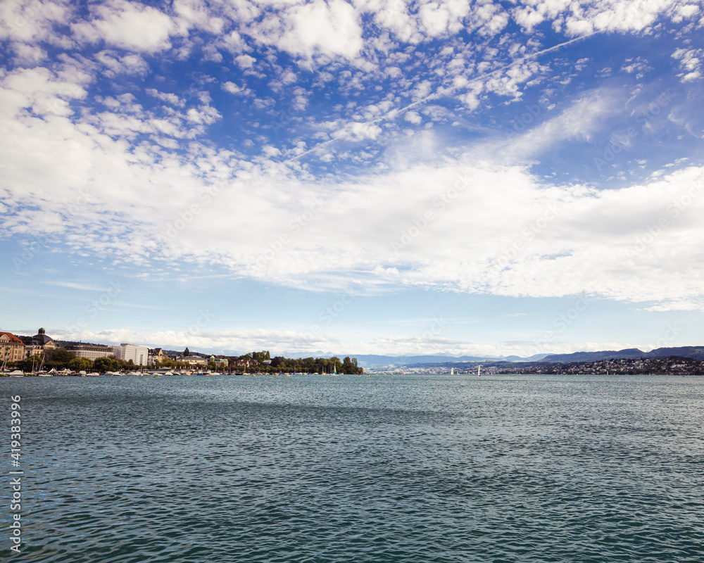 Panoramic view of historic Zurich city center with famous Opera House at Lake Zurich on a sunny day with clouds in summer, Canton of Zurich, Switzerland Panoramic view of historic Zurich city center with famous Opera House at Lake Zurich on a sunny day with clouds in summer, Canton of Zurich, Switzerland