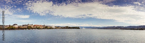 Panoramic view of historic Zurich city center with famous Opera House at Lake Zurich on a sunny day with clouds in summer, Canton of Zurich, Switzerland © George Mota