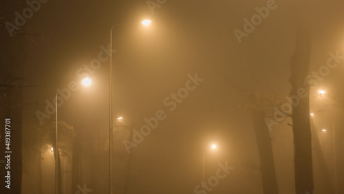 city lights in the thick fog at night