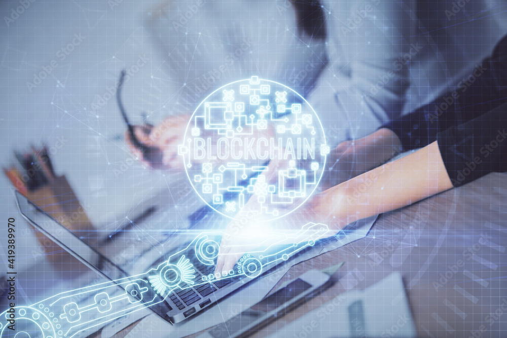 Double exposure of woman hands typing on computer and crypto market theme hologram drawing. Blockchain concept. Double exposure of woman hands typing on computer and crypto market theme hologram drawing. Blockchain concept.