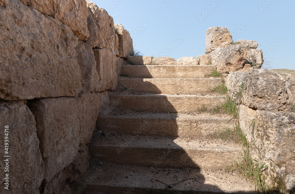 Remains  of well-preserved stone steps in the ruins of the outer part of the palace of King Herod - Herodion,in the Judean Desert, in Israel