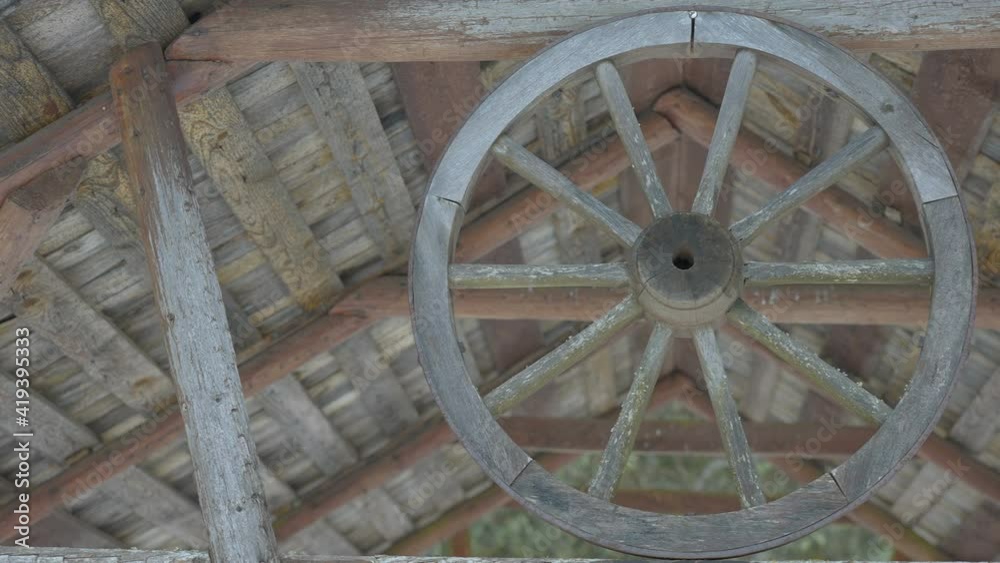 The wooden wheel on the cabin house in the forest during the winter in Estonia The wooden wheel on the cabin house in the forest during the winter in Estonia