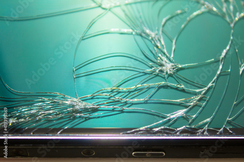 crack on the glass of the phone, closeup, the frame of the phone is visible