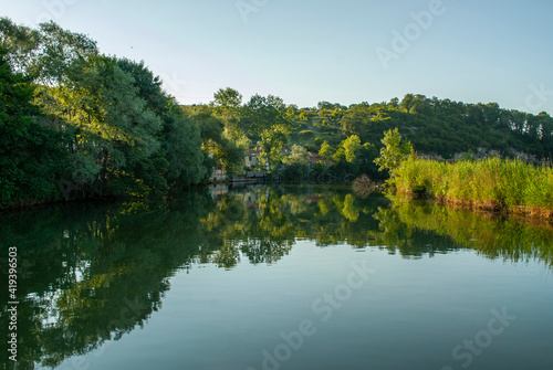 Agva, Sile, Istanbul, Turkey. It's a popular place place and resort destination on Goksu river. Reflection of trees. Reflections in the water. © osman