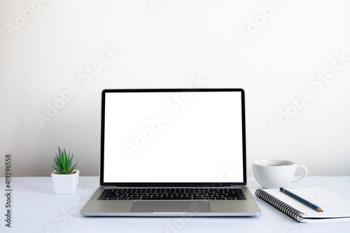 White office desk table with keyboard of laptop, coffee cup and notebook, mouse computer with equipment office supplies. Business and finance concept. Workplace, Flat lay with blank copy space.