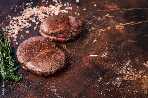 Grilled Fillet Mignon tenderloin meat beef steaks. Dark background. Top view. Copy space