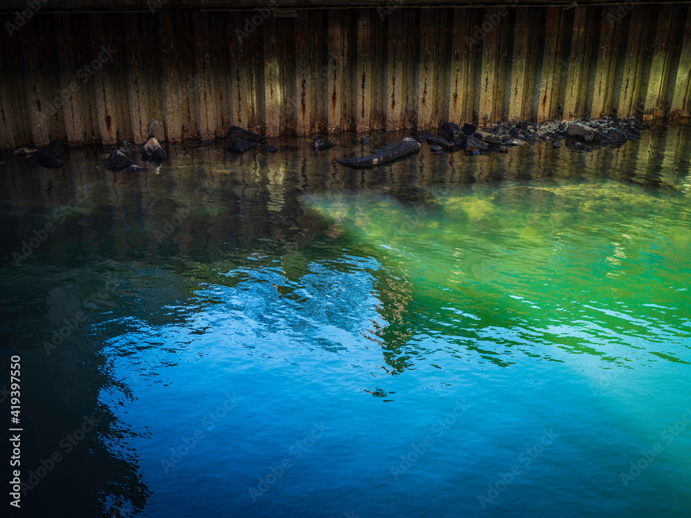 Green and Blue Sea Water Reflections under the Boston Harbor Dock