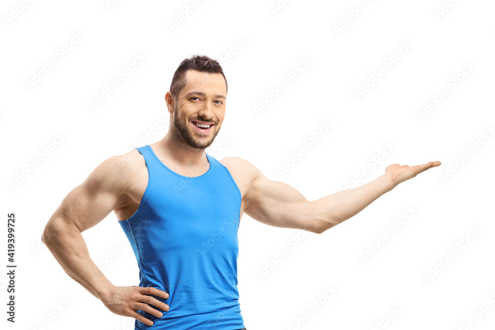 Young muscular man in sportswear showing with his hand Young muscular man in sportswear showing with his hand