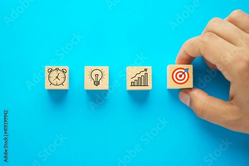 Business process management, Businessman plan a project with wooden cubes with icon business strategy on blue background. copy space © theserhat