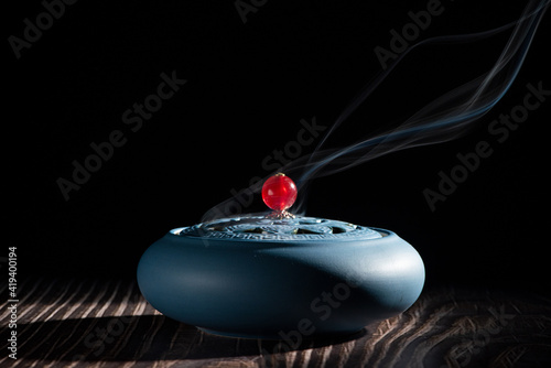 incense burner censer with smoke on black background.