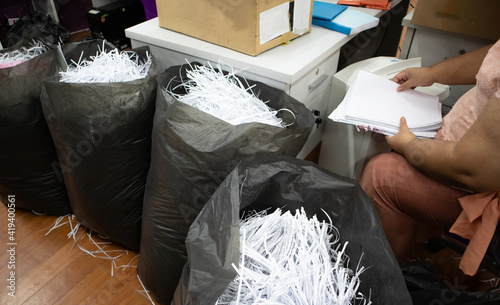 Fotografie Secretary destroys documents using a shredder.