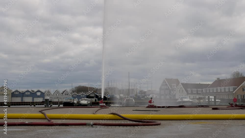Fire brigade exercise water jet hoses in Dutch harbor Huizen Fire brigade exercise water jet hoses in Dutch harbor Huizen