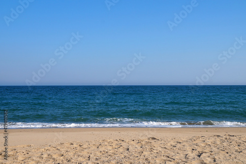 empty sandy beach, sea horizon and clear sky © Anna