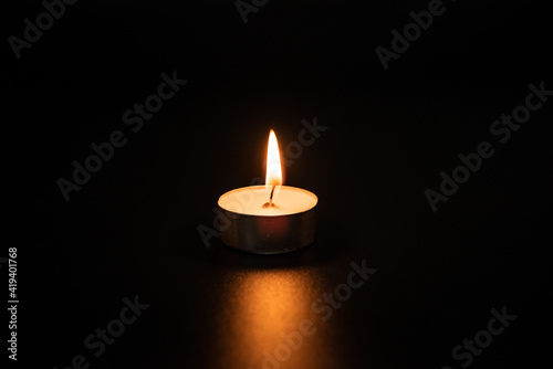 candles burning at night.Many candle flames glowing on dark background