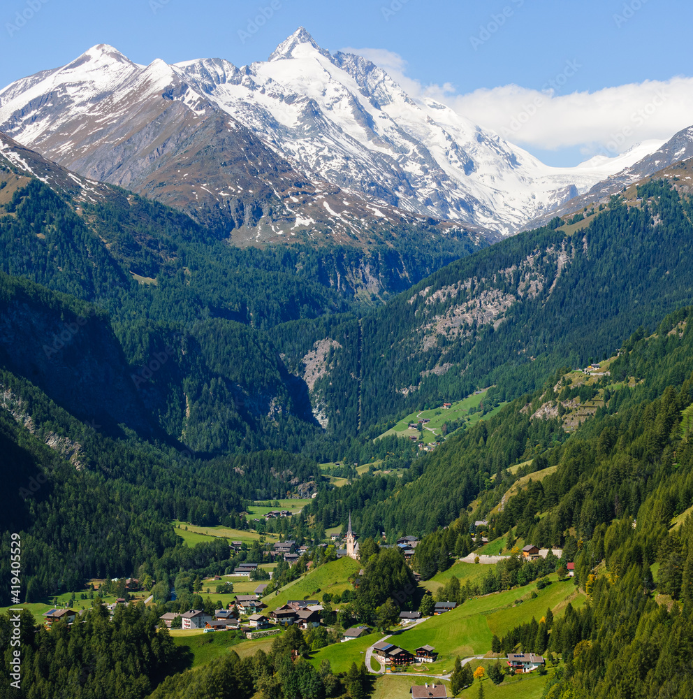 Green valley in front of snow covered mountain Green valley in front of snow covered mountain