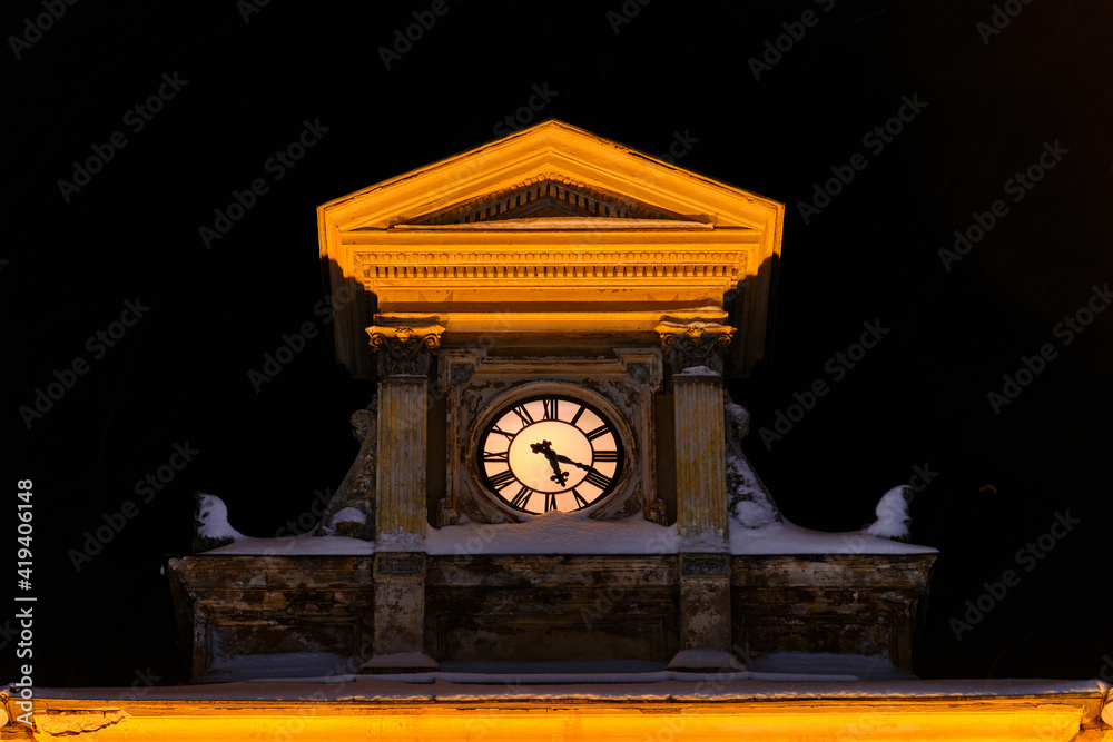 The clock on the Porvoo contemporary Townhall in winter snowy night, Finland.