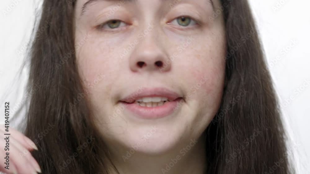Drowsiness and fatigue. A young, sleepy woman yawns. Close-up view. White background. Soft focus Drowsiness and fatigue. A young, sleepy woman yawns. Close-up view. White background. Soft focus