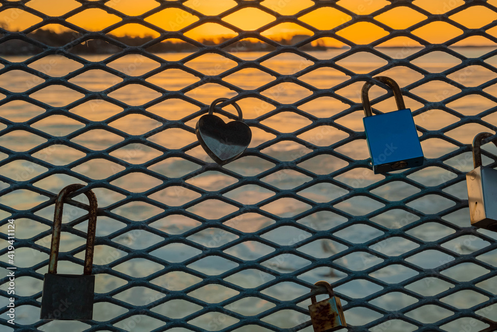 Locks of love on the fence nid at sea and dawn. Helsinki Locks of love on the fence nid at sea and dawn. Helsinki