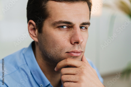 Close up of a pensive attractive young business man