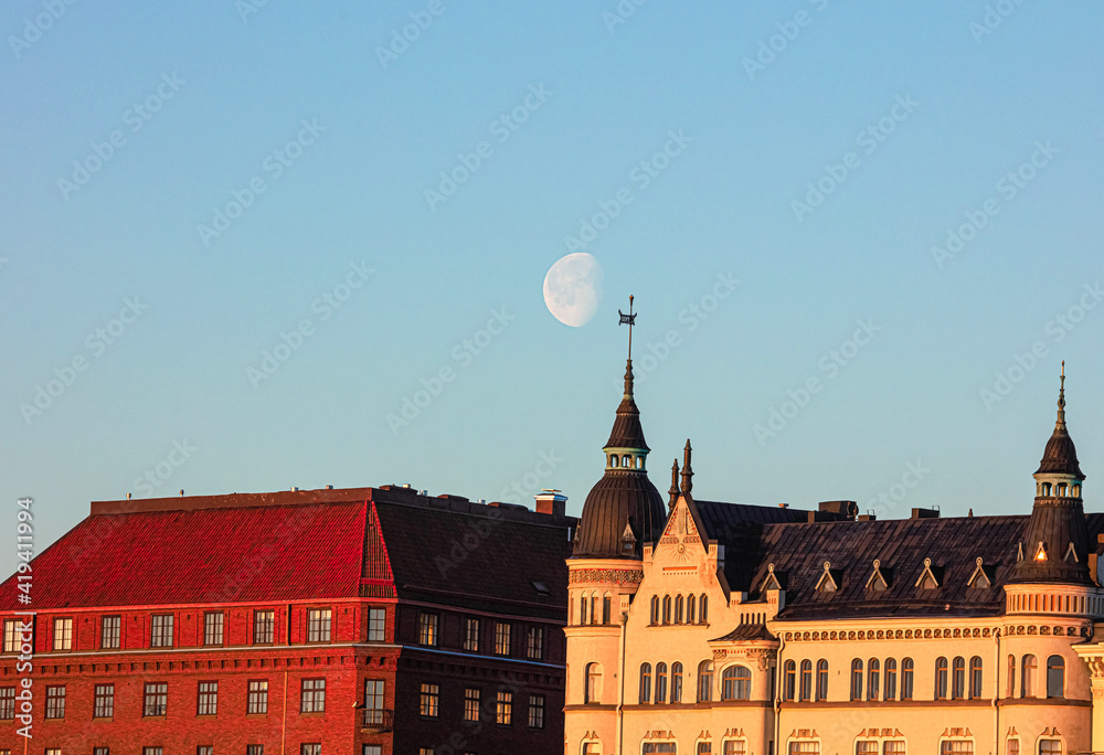 Φωτογραφία Moon in the sky, Dawn, Spring panorama of Helsinki, view on
  rooftops of Krunun