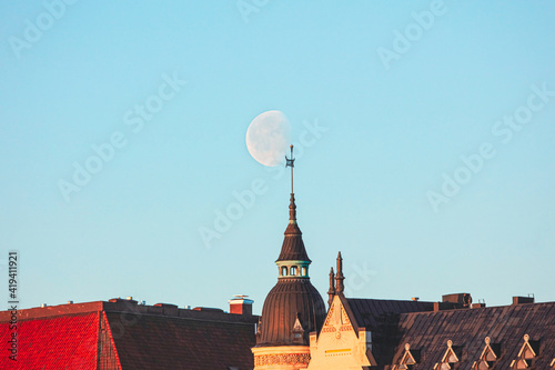 Moon in the sky, Dawn, Spring panorama of Helsinki, view on
  rooftops of Krununhakka buildings photo