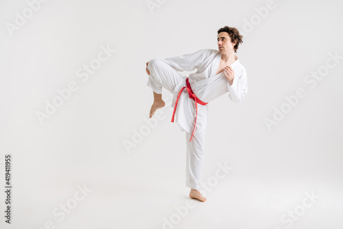 Karate man exercising isolated against