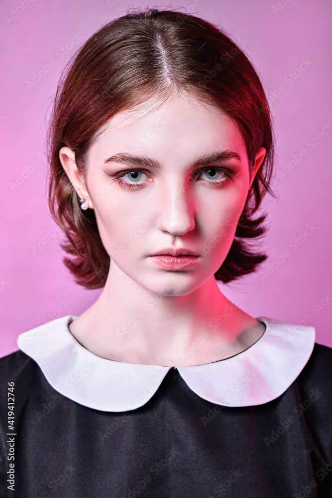 dramatic mysterious portrait of young girl. pink background dramatic mysterious portrait of young girl. pink background