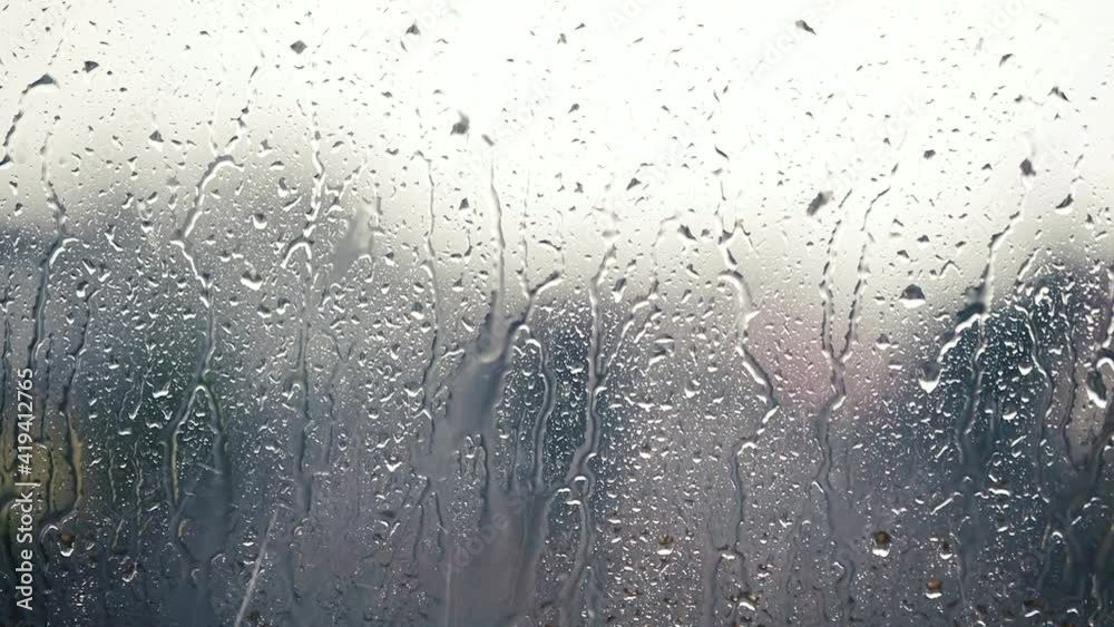 heavy rain falling on the window surface
