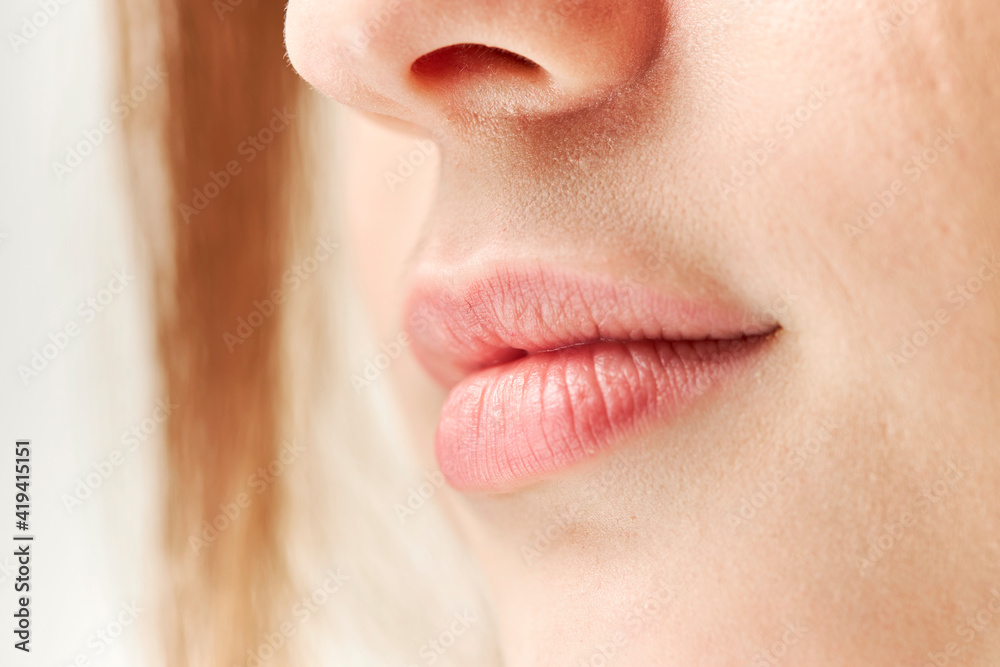 Obraz premium Part of face,young woman close up. Plump lips without makeup