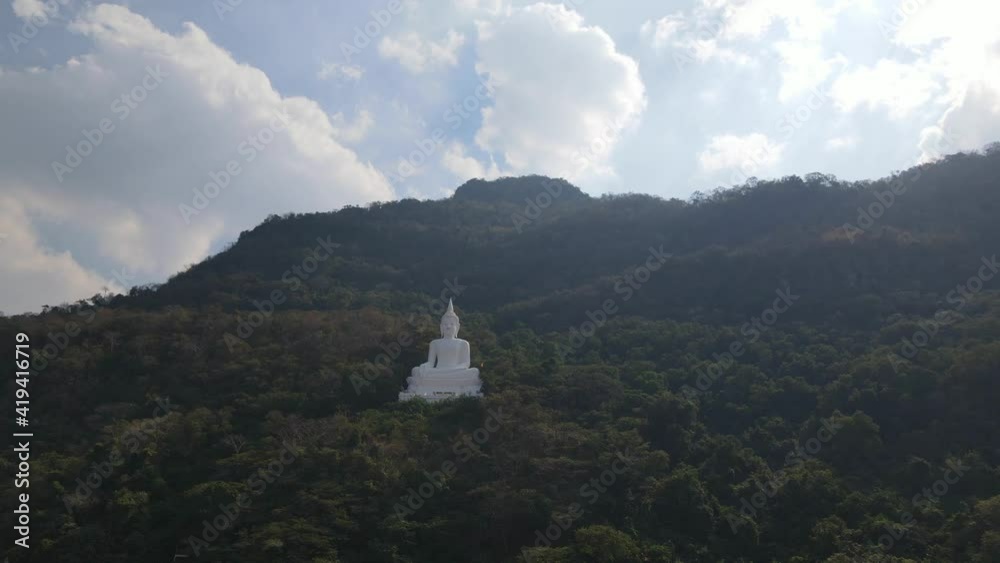 custom made wallpaper toronto digitalLuang Por Khao, Wat Theppitak Punnaram, an aerial sliding shot to the right revealing the famous white Buddhist statue and the mountain side covered with trees changing colours, beautiful cloudy sky.