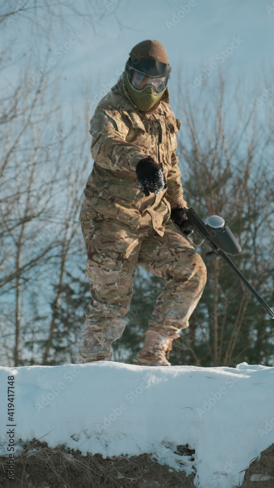 hunter with a paintball rifle hunter with a paintball rifle
