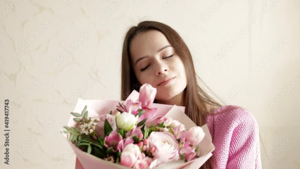 Caucasian girl with a bouquet of beautiful flowers on an anniversary or birthday Caucasian girl with a bouquet of beautiful flowers on an anniversary or birthday