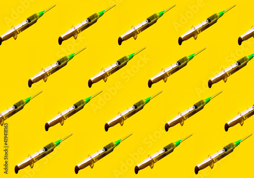 Wallpaper Mural Pattern of a syringe on yellow background. Covid-19 vaccination concept and hope Torontodigital.ca
