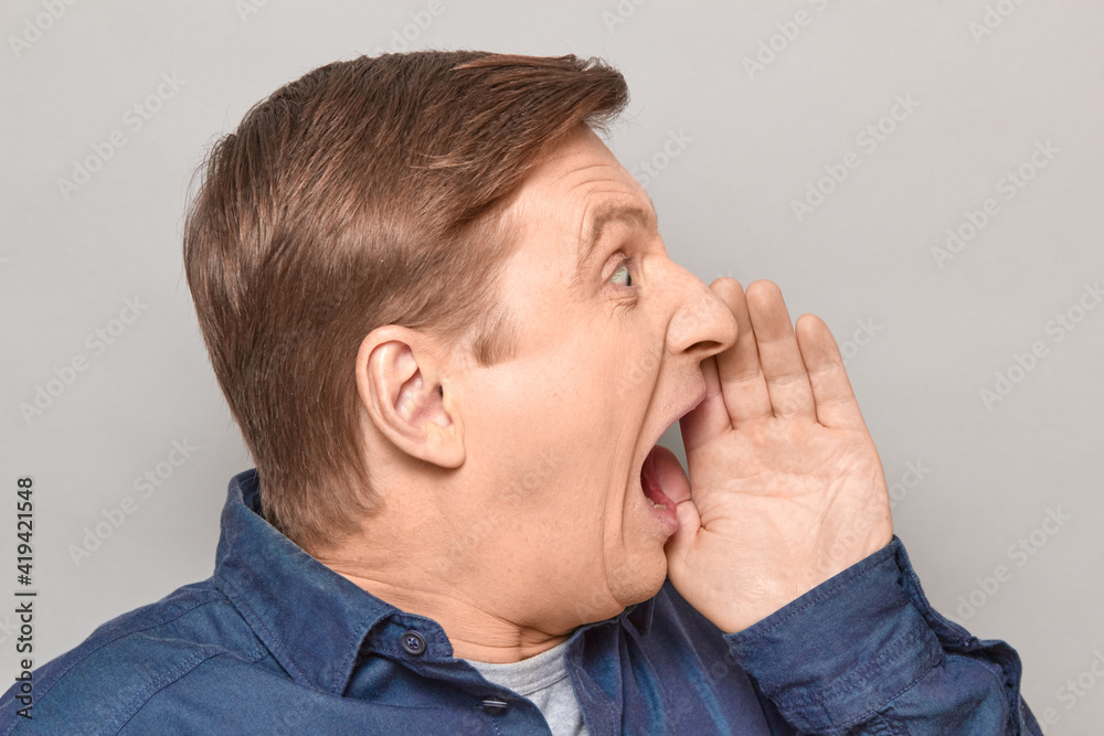 Portrait of man shouting in full voice and calling someone Portrait of man shouting in full voice and calling someone