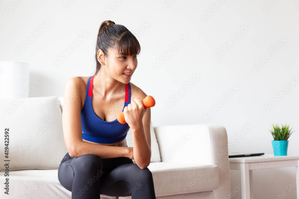 Sporty girl having weight exercise at home