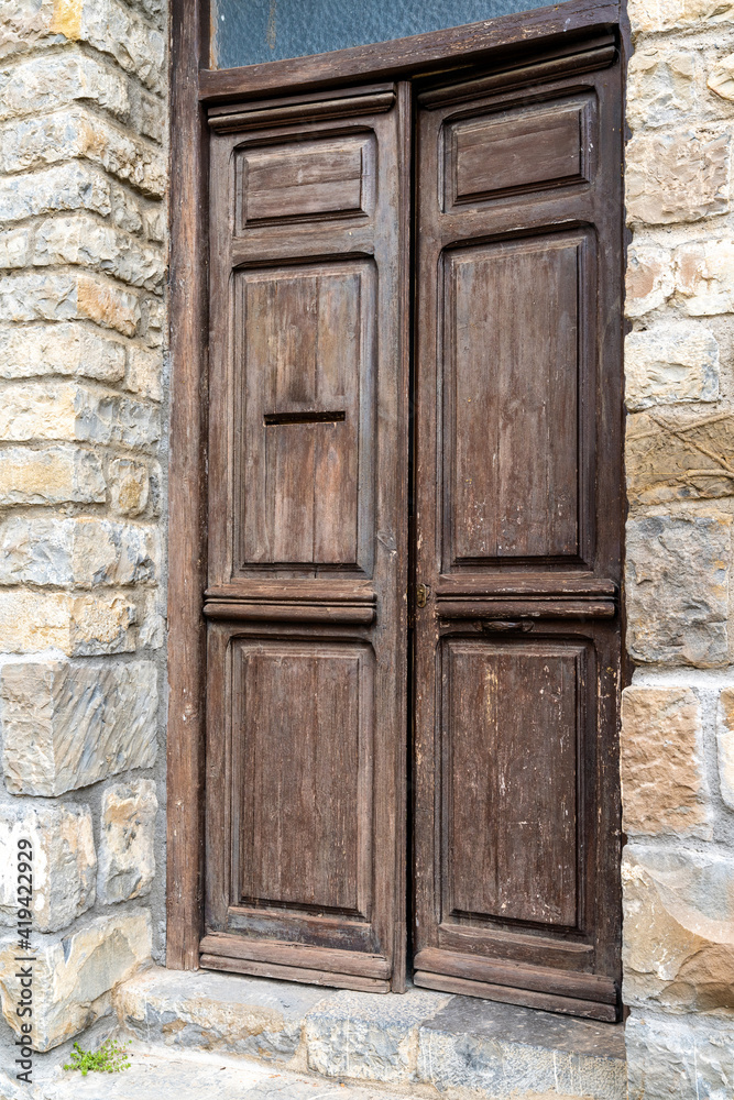 massive brown wooden door in a massive brown stone building massive brown wooden door in a massive brown stone building