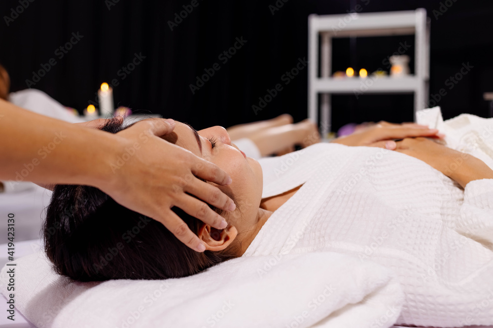 An Asian girl is relax while having head massage in spa salon An Asian girl is relax while having head massage in spa salon