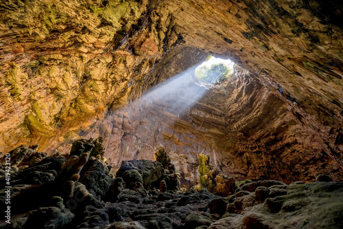 Tela La Grave abyss of Grotte di Castellana with ray of sunlight in Puglia