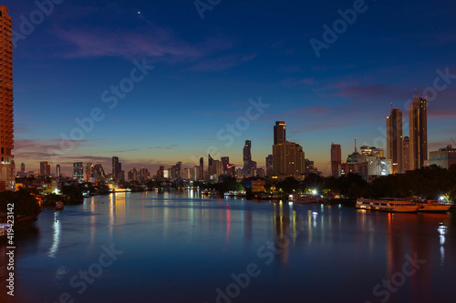 Bangkok Chaopraya river at night time with downtown building in background