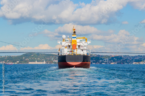 Stern of huge bulk cargo ship passes through the Bosporus Strait, Istanbul, Turkey. International sea freight concept background.