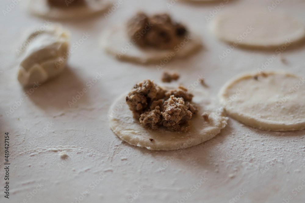 Variki with meat and mushrooms. They lie on the table. Dough. Variki with meat and mushrooms. They lie on the table. Dough.