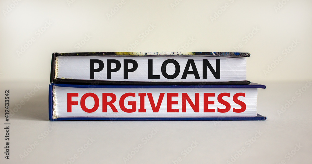 PPP, paycheck protection program loan forgiveness symbol. Concept words PPP, paycheck protection program loan forgiveness on books on a white background. Business, PPP loan forgiveness concept.